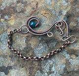 This Lovely Blue Apatite and Wire Wrapped Copper Wave Bracelet is a stunning piece of jewelry featuring vibrant blue apatite stones set against an intricate copper wave design. The bracelet combines the natural beauty of apatite with the elegance of wire-wrapped copper to create a unique and eye-catching accessory.