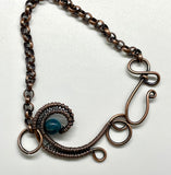 This Lovely Blue Apatite and Wire Wrapped Copper Wave Bracelet is a stunning piece of jewelry featuring vibrant blue apatite stones set against an intricate copper wave design. The bracelet combines the natural beauty of apatite with the elegance of wire-wrapped copper to create a unique and eye-catching accessory.