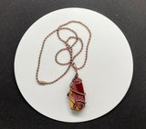 Heavy Gauge Copper that has been hammered and formed around this tumbled Mookaite Jasper. This Necklace is reversible and can be worn with either side facing out.