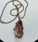 Heavy Gauge Copper that has been hammered and formed around this tumbled Mookaite Jasper. This Necklace is reversible and can be worn with either side facing out.
