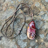 Heavy Gauge Copper that has been hammered and formed around this tumbled Mookaite Jasper. This Necklace is reversible and can be worn with either side facing out.