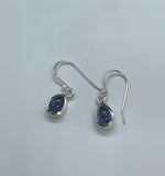 These elegant earrings showcase beautiful Blue Kyanite stones set in Sterling Silver. The deep, vibrant blue of the Kyanite contrasts beautifully with the sleek, polished silver, creating a sophisticated and timeless look. The earrings offer a touch of refined elegance and are perfect for adding a pop of color to any ensemble.