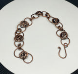 This Copper Flower Bud Bracelet is ideal for individuals who appreciate handcrafted jewelry with a touch of nature-inspired design. It appeals to those who love elegant, feminine accessories and value artisanal craftsmanship. This bracelet is perfect for those looking for a unique piece that can be worn daily or on special occasions.