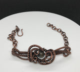 This Wire Wrapped Copper Bracelet with Agate is a stunning piece that beautifully marries the elegance of Agate with the intricate artistry of wire wrapping. Its adjustable design ensures a comfortable fit for various wrist sizes, making it a versatile and attractive addition to any jewelry collection.