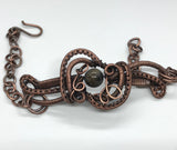 This Wire Wrapped Copper Bracelet with Agate is a stunning piece that beautifully marries the elegance of Agate with the intricate artistry of wire wrapping. Its adjustable design ensures a comfortable fit for various wrist sizes, making it a versatile and attractive addition to any jewelry collection.