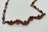 This delicate copper bracelet features an elegant wave design, accented with shimmering glass beads for a touch of color and sparkle. The bracelet is adjustable from 7 ½ to 9 inches, providing a comfortable fit, and can be shortened upon request. The warm tones of the copper combined with the playful, flowing wave design make this piece a versatile accessory for both casual and formal looks. Perfect for those who appreciate subtle elegance with a handcrafted touch.