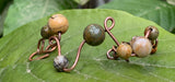 This unique bracelet is handcrafted from heavy gauge copper, shaped and curved into an organic freeform design. Accented with Picasso Jasper beads, known for their intricate natural patterns and earthy tones, The warm hues of the copper beautifully complement the stone’s striking marbled appearance. A bold statement bracelet for those who appreciate artisan craftsmanship and nature-inspired jewelry.