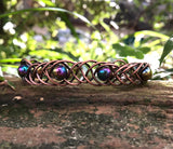 This unique 7" cuff bracelet features sturdy 18-gauge copper braided together with vibrant rainbow glass beads, creating a stunning contrast of warm metal and colorful accents. The intricate braid adds texture and depth, while the glass beads catch the light, adding a playful shimmer. Perfect for anyone who loves handcrafted, statement jewelry, this cuff is both bold and comfortable for everyday wear.