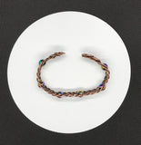 This unique 7" cuff bracelet features sturdy 18-gauge copper braided together with vibrant rainbow glass beads, creating a stunning contrast of warm metal and colorful accents. The intricate braid adds texture and depth, while the glass beads catch the light, adding a playful shimmer. Perfect for anyone who loves handcrafted, statement jewelry, this cuff is both bold and comfortable for everyday wear.