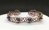 This unique 7" cuff bracelet features sturdy 18-gauge copper braided together with vibrant rainbow glass beads, creating a stunning contrast of warm metal and colorful accents. The intricate braid adds texture and depth, while the glass beads catch the light, adding a playful shimmer. Perfect for anyone who loves handcrafted, statement jewelry, this cuff is both bold and comfortable for everyday wear.