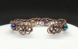 This unique 7" cuff bracelet features sturdy 18-gauge copper braided together with vibrant rainbow glass beads, creating a stunning contrast of warm metal and colorful accents. The intricate braid adds texture and depth, while the glass beads catch the light, adding a playful shimmer. Perfect for anyone who loves handcrafted, statement jewelry, this cuff is both bold and comfortable for everyday wear.