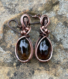 Copper embraces smoky quartz in these earrings, the stones glinting like twilight through mist. Niobium ear wires complete the design with a gentle, skin-friendly touch.