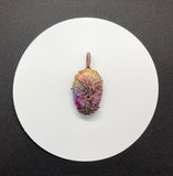 This Rainbow Quartz Tree of Life Pendant is a vibrant and enchanting piece featuring dyed Rainbow Quartz wrapped in intricate copper wire. This pendant combines the rich, multicolored beauty of Rainbow Quartz with the organic symbolism of the Tree of Life, creating a stunning and meaningful accessory.