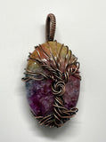 This Rainbow Quartz Tree of Life Pendant is a vibrant and enchanting piece featuring dyed Rainbow Quartz wrapped in intricate copper wire. This pendant combines the rich, multicolored beauty of Rainbow Quartz with the organic symbolism of the Tree of Life, creating a stunning and meaningful accessory.