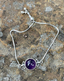 Elevate your accessory collection with the Adjustable Sterling Silver (.925) and Amethyst Bracelet. This elegant bracelet combines the timeless beauty of sterling silver with the enchanting allure of amethyst, offering a piece that is both versatile and sophisticated.