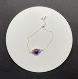Elevate your accessory collection with the Adjustable Sterling Silver (.925) and Amethyst Bracelet. This elegant bracelet combines the timeless beauty of sterling silver with the enchanting allure of amethyst, offering a piece that is both versatile and sophisticated.