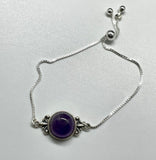 Elevate your accessory collection with the Adjustable Sterling Silver (.925) and Amethyst Bracelet. This elegant bracelet combines the timeless beauty of sterling silver with the enchanting allure of amethyst, offering a piece that is both versatile and sophisticated.