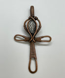 This powerful pendant features an intricately handcrafted copper Ankh—the ancient Egyptian symbol of life—formed with a blend of hammered texture and detailed wire wrapping. At its center rests a unique Snakeskin Stone, with earthy patterns that echo nature’s raw beauty. A striking, symbolic piece for those who appreciate spiritual meaning and artisan craftsmanship.