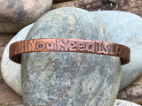 This beautifully handcrafted copper bangle features an etched inscription of the timeless phrase, "All You Need is Love." The warm, earthy tones of the copper complement the deep etching, creating a rustic yet elegant look. The bangle has been carefully shaped, oxidized, and polished to enhance its texture and design, making it a meaningful and stylish accessory.