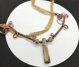 Embrace the elegance of nature and artistry with the Stunning Woven Copper Necklace. Featuring a striking combination of Picasso Jasper, copper beads, and a silk ribbon cord, this necklace is a unique statement piece that beautifully blends organic beauty with sophisticated design.