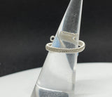 This elegant ring features a stunning Blue Chalcedony gemstone, wrapped in wire with Argentium Silver for a refined and durable finish. The ring is adjustable, accommodating sizes 5 to 8, ensuring a perfect fit for any finger. The soft blue hue of the chalcedony contrasts beautifully with the bright, shiny silver, creating a sophisticated and versatile piece that can complement any style.