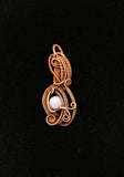 Handmade woven copper pendant with Tourmalinated Quartz quartz bead.