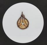 This stunning Crazy Lace Agate pendant showcases intricate copper wire wrapping. The agate's vibrant patterns are beautifully highlighted by the handwoven copper, creating a distinctive and eye-catching piece. The detailed craftsmanship enhances the natural beauty of the stone, making it a unique addition to any jewelry collection.