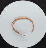 This striking bracelet is crafted from heavy gauge copper that has been expertly annealed and hammered, creating a unique texture that catches the light beautifully. The organic design showcases the rich warmth of copper, making it a standout piece in any jewelry collection. Comfortable and lightweight, this bracelet is a true testament to the beauty of handcrafted jewelry.