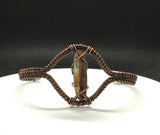 This bracelet showcases the natural beauty of blue and brown kyanite, elegantly wrapped in warm copper wire. The combination of earthy browns and deep blues creates a harmonious, grounding energy, while the handcrafted copper wrapping adds an artisan touch.