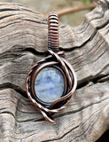This Rainbow Moonstone Mini Pendant in Copper is a beautifully crafted accessory that highlights the ethereal beauty of Rainbow Moonstone within a delicately designed copper setting. Its miniature size and elegant design make it a versatile and enchanting piece, perfect for adding a touch of magic to any outfit.