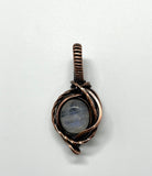 This Rainbow Moonstone Mini Pendant in Copper is a beautifully crafted accessory that highlights the ethereal beauty of Rainbow Moonstone within a delicately designed copper setting. Its miniature size and elegant design make it a versatile and enchanting piece, perfect for adding a touch of magic to any outfit.