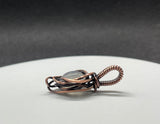 This Rainbow Moonstone Mini Pendant in Copper is a beautifully crafted accessory that highlights the ethereal beauty of Rainbow Moonstone within a delicately designed copper setting. Its miniature size and elegant design make it a versatile and enchanting piece, perfect for adding a touch of magic to any outfit.