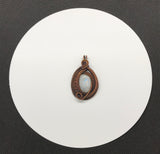 This pendant features layers of intricately wire wrapped copper surrounding an iridescent rainbow moonstone. The combination of detailed copper wirework and the moonstone’s enchanting play of colors creates a visually stunning and sophisticated piece of jewelry.