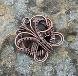 Welcome in the warmth of spring and summer with this whimsical butterfly pendant, lovingly crafted in wire-wrapped copper. Delicate curves and graceful lines bring this symbol of transformation and renewal to life, making it a beautiful reminder of nature’s cycles. Lightweight and full of charm, it's the perfect piece to celebrate the season or gift to someone embracing new beginnings.