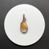 This Colorful Lace Agate Pendant in Wire Wrapped Copper is ideal for individuals who appreciate the beauty of natural gemstones and the artistry of handcrafted jewelry. It appeals to those who love unique, statement pieces with vibrant colors and intricate designs. This pendant is perfect for fashion-forward individuals who value both style and the natural charm of gemstones.