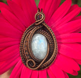 This pendant features layers of intricately wire wrapped copper surrounding an iridescent rainbow moonstone. The combination of detailed copper wirework and the moonstone’s enchanting play of colors creates a visually stunning and sophisticated piece of jewelry.