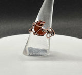 This ring features a beautifully carved Red Jasper crescent moon, wrapped in warm copper wire for an earthy and elegant design. The adjustable band allows for a comfortable fit, making it a versatile addition to any jewelry collection. Red Jasper, known for its grounding and protective properties, adds a bold yet natural touch to this handcrafted piece. Perfect for moon lovers and those who appreciate unique, artisan jewelry!