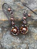 Shimmering rainbow-colored glass seed beads dance along warm copper wire, creating a joyful burst of color in every movement. Finished with hypoallergenic niobium ear wires, these earrings are as comfortable as they are eye-catching — perfect for adding a playful pop to any outfit.