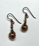 Shimmering rainbow-colored glass seed beads dance along warm copper wire, creating a joyful burst of color in every movement. Finished with hypoallergenic niobium ear wires, these earrings are as comfortable as they are eye-catching — perfect for adding a playful pop to any outfit.