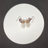 Wire Wrapped Copper and Glass Bottle Earrings filled with Clear and Light Smoky Quartz Tumbles on Niobium Ear Wires.