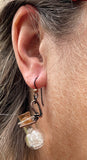 These whimsical earrings feature tiny glass bottles wrapped in warm copper, each filled with a mix of clear and light smoky quartz tumbles. Hanging from hypoallergenic niobium ear wires, they’re lightweight, playful, and full of earthy charm. A unique design that combines craftsmanship with a touch of crystal magic.