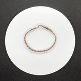 This bracelet features multiple strands of copper skillfully braided together, creating a rich texture and visual interest. Each strand has been hammered to enhance its natural shine and add a unique artisanal touch. The bracelet showcases the warm tones of copper, making it a versatile accessory for any occasion.
