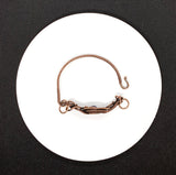 Handwoven Copper Weaves surround a beautiful Peacock Pearl in this handmade bracelet.