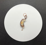 This Crazy Lace Agate Moon Pendant is a stunning piece of jewelry featuring a moon-shaped Crazy Lace Agate gemstone wrapped in copper wire with a Quartz star dangle. Known for its intricate patterns and vibrant colors, Crazy Lace Agate adds a unique and whimsical touch to this celestial-themed pendant. The addition of the Quartz star dangle enhances its charm and makes it a distinctive and elegant accessory.
