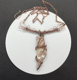 Make a bold statement with this Crazy Lace Agate Necklace, featuring a stunning piece of crazy lace agate set in intricate wire-wrapped copper. The unique patterns and vibrant colors of the agate are beautifully highlighted by the handcrafted copper setting, creating a striking and elegant necklace.