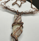 Make a bold statement with this Crazy Lace Agate Necklace, featuring a stunning piece of crazy lace agate set in intricate wire-wrapped copper. The unique patterns and vibrant colors of the agate are beautifully highlighted by the handcrafted copper setting, creating a striking and elegant necklace.