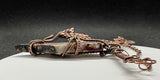 Make a bold statement with this Crazy Lace Agate Necklace, featuring a stunning piece of crazy lace agate set in intricate wire-wrapped copper. The unique patterns and vibrant colors of the agate are beautifully highlighted by the handcrafted copper setting, creating a striking and elegant necklace.