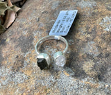 This captivating ring showcases the natural beauty of raw Quartz and raw Moldavite, set in sterling silver for a rustic yet elegant look. The adjustable band fits sizes 6 ½ and up, offering versatility and comfort. The clear, uncut Quartz radiates purity, while the rare, deep green Moldavite adds a touch of otherworldly mystique. Together, these stones are believed to enhance spiritual growth and energy. Perfect for those who appreciate raw, organic beauty, this ring is a unique and powerful statement piece