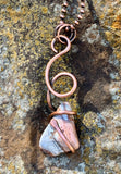 This bold, one-of-a-kind necklace features a tumbled Crazy Lace Agate, securely embraced by hammered and hand-formed heavy gauge copper. The natural swirls and banding of the agate are beautifully contrasted by the rugged texture and warm tone of the copper. A powerful statement of organic design and artisan craftsmanship—earthy, eye-catching, and full of character.