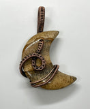 This captivating pendant features a beautiful Picture Jasper stone in a crescent moon shape, wrapped in warm, handwoven copper wire. The natural earthy tones and intricate patterns of the Picture Jasper evoke a sense of grounding and connection to nature, while the copper wire adds a rustic elegance. Perfect for those who appreciate celestial designs and the beauty of handcrafted jewelry, this pendant makes a stunning and meaningful accessory.